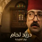 صورة غلاف مقالة دريد لحام تُظهر صورة شخصية لفنان مسن بملامح عربية وابتسامة خفيفة مع خلفية دمشقية تقليدية وإضاءة سينمائية دافئة